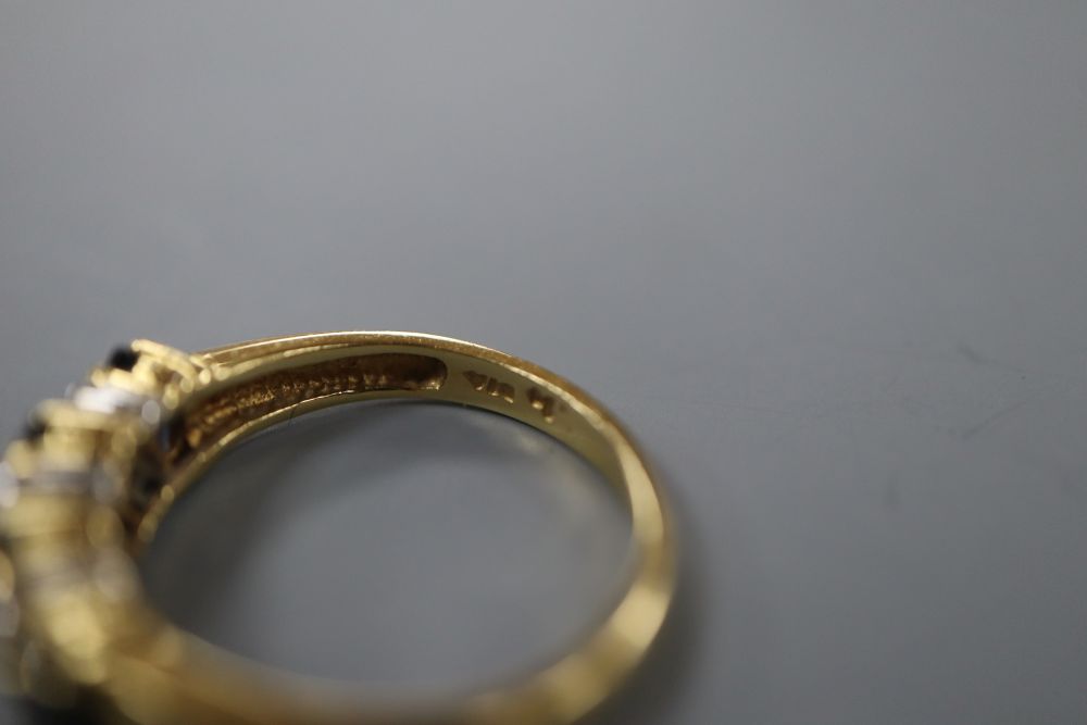 A modern 18ct gold, sapphire and diamond set half hoop ring, size L, gross 3.3 grams.